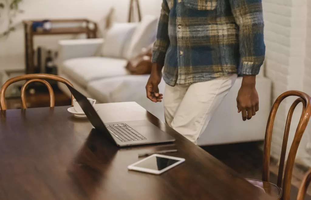 Crop black man working at home